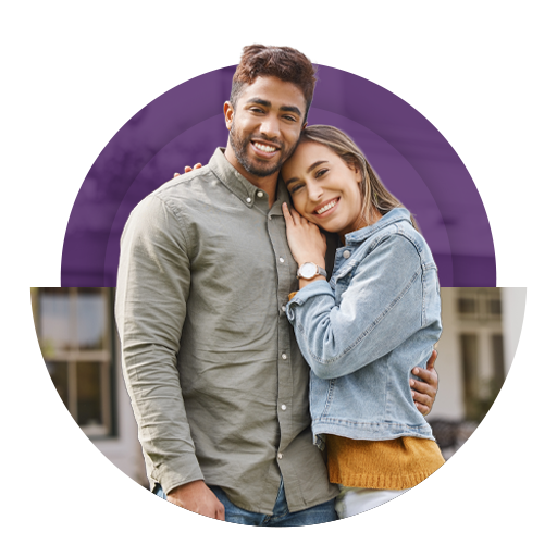 Casal sorrindo abraçado em destaque sobre fundo roxo e ambiente urbano desfocado.
